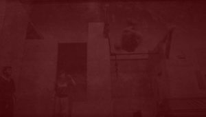 A red background with some people in the corner