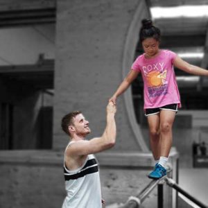 A man and girl are high fiving on the stairs.