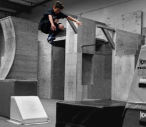 A man flying through the air while riding a skateboard.