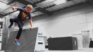 A man riding on the side of a skateboard ramp.