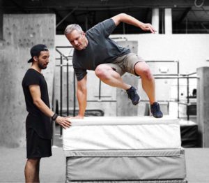 A man jumping over an object in the air.