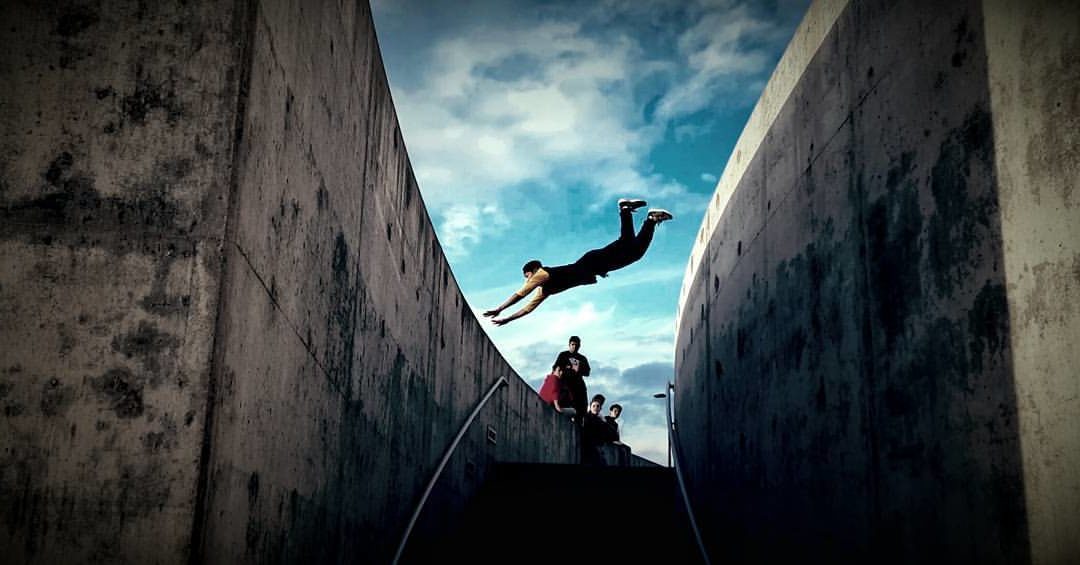 A man flying through the air while riding a skateboard.